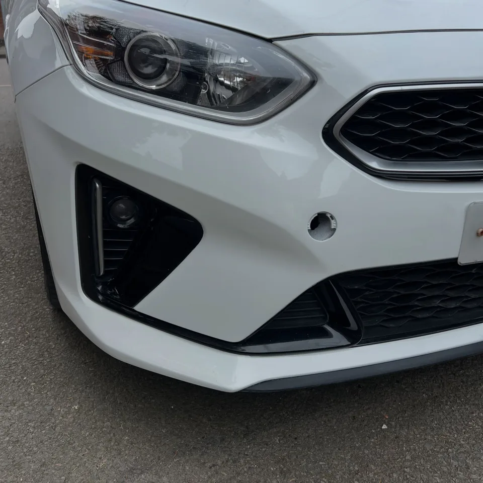 White Kia front bumper after cosmetic repair